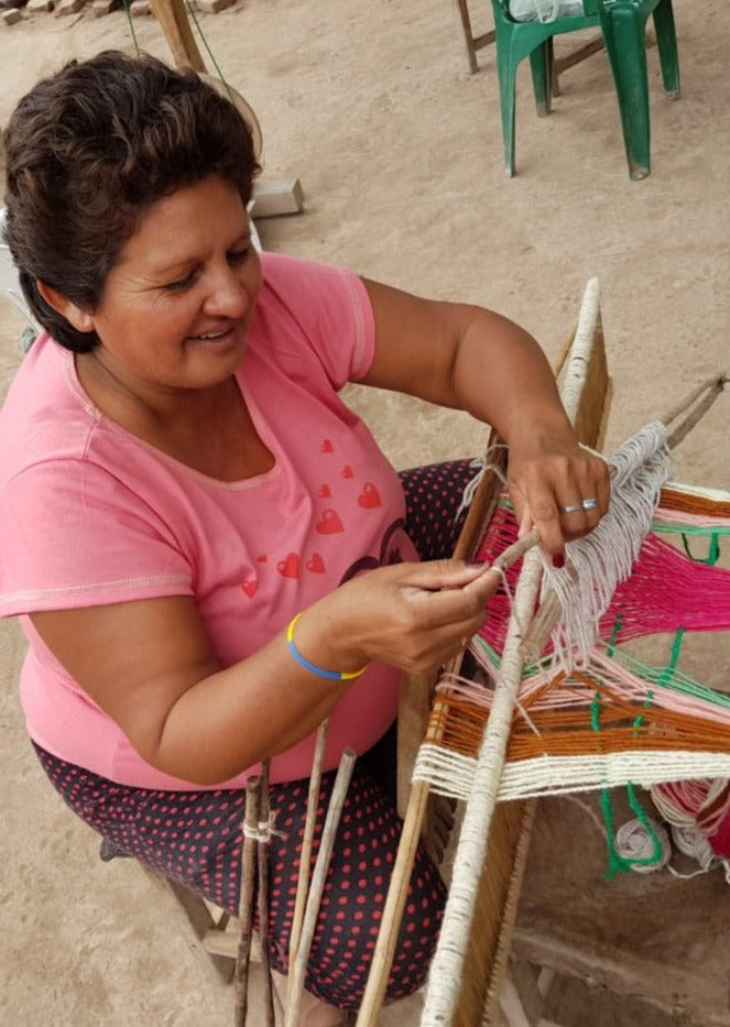 Artisan handcrafting hand spun, hand dyed and handwoven ruanas